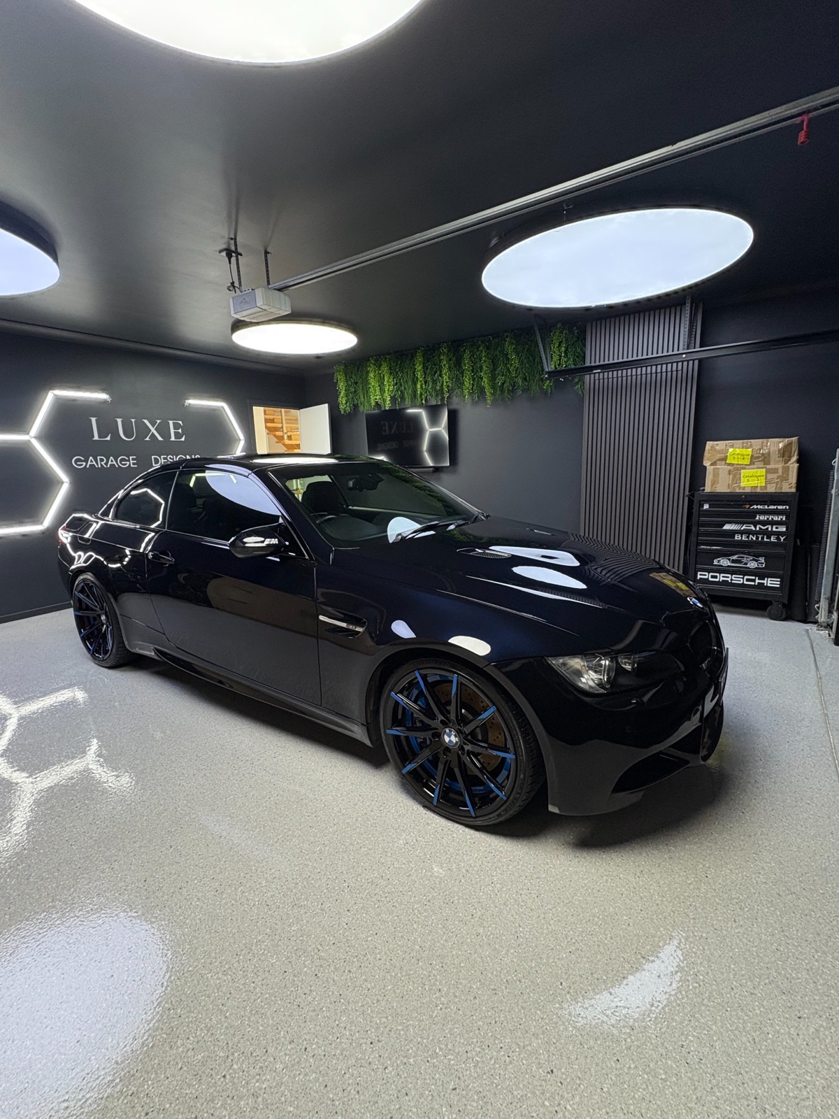 Blue BMW E92 M3 with a glossy finish at the Luxe Motors workshop